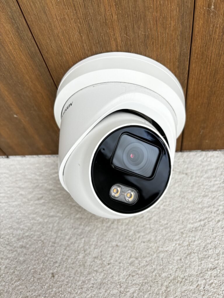 Sleek dome CCTV camera installation with built-in LED lights for night vision, ideal for indoor and outdoor surveillance in homes or businesses.