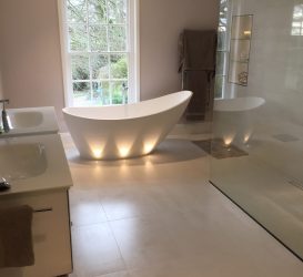 Elegant bathroom featuring integrated downlights and under-bath LED lighting, creating a soft, ambient glow that enhances the luxurious and modern design.