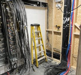 Electrical wiring installation in progress, showcasing organised cable management for power and data systems, with a focus on routing and preparation in a dedicated control room.