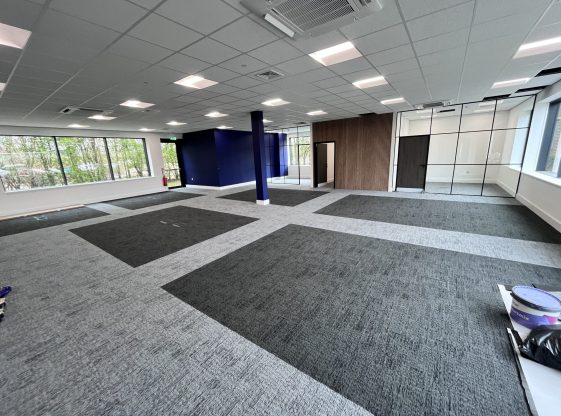 Modern office space with integrated ceiling lighting and concealed electrical infrastructure, providing a clean and efficient environment ready for occupancy and flexible workspace configurations.